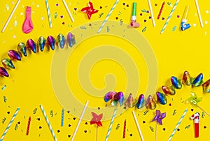 Bithday party decorations on yellow background, top view