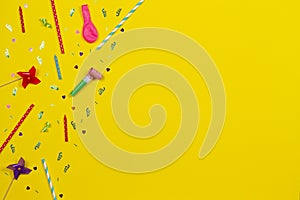 Bithday party decorations on yellow background, top view