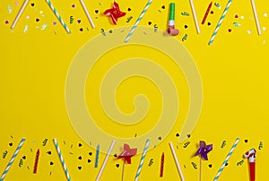 Bithday party decorations on yellow background, top view