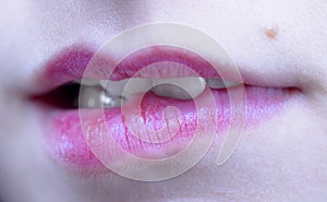 Biting her red lips teeth