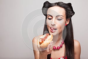 Biting off a hot dog pinup smiling model