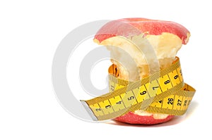 Bitten apple and measure tape