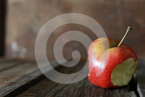Bitten apple on a wooden background