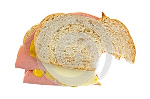 Bitten baloney sandwich with cheese photo