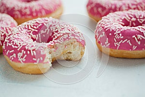 Bitten donut. Sweet icing sugar food. Dessert colorful snack. Glazed sprinkles. Treat from delicious pastry breakfast. Bakery cake