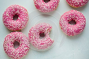 Bitten donut. Sweet icing sugar food. Dessert colorful snack. Glazed sprinkles. Treat from delicious pastry breakfast. Bakery cake