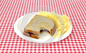 Bitten grape jelly sandwich on wheat
