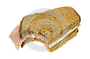 Bitten ham and cheese sandwich on a white background