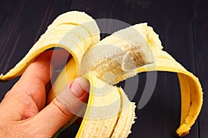 Bitten off banana in hand closeup