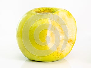 Bitten yellow apple fruit on plate on white