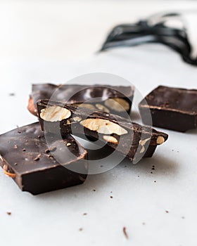 Bitter Almond Chocolate Pieces on White Marble Surface