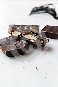 Bitter Almond Chocolate Pieces on White Marble Surface