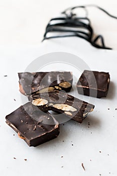 Bitter Almond Chocolate Pieces on White Marble Surface