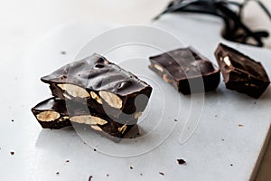 Bitter Almond Chocolate Pieces on White Marble Surface