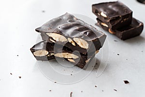 Bitter Almond Chocolate Pieces on White Marble Surface