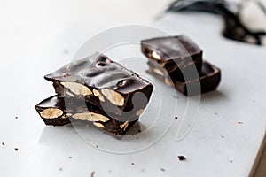 Bitter Almond Chocolate Pieces on White Marble Surface