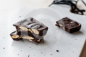 Bitter Almond Chocolate Pieces on White Marble Surface