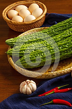 Bitter gourd and egg on the table