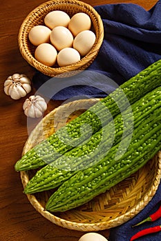 Bitter gourd and egg on the table