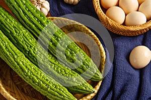 Bitter gourd and egg on the table