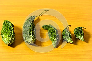 Bitter gourd green pieces closeup on isolated table background