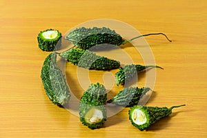 Bitter gourd green pieces closeup on isolated table background