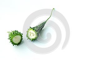 Bitter gourd with leaves on white background