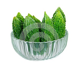 Bitter gourd pile in clear Glass bowl on white background. vegetable herb Nourish the health body