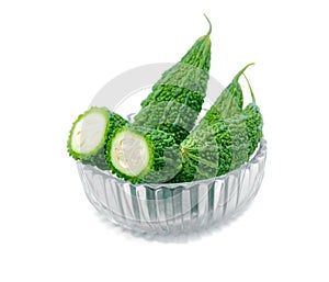 Bitter gourd pile in Glass bowl on white background. vegetable herb Nourish the health body