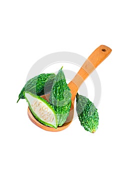 Bitter gourd pile with piece in Wooden spoon on white background. vegetable herb Nourish the health body