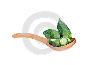 Bitter gourd pile with piece in Wooden spoon on white background. vegetable herb Nourish the health body