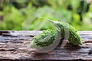 Bitter melon on old wooden background