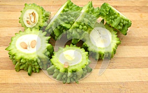 Bitter melon and slice on wooden background photo