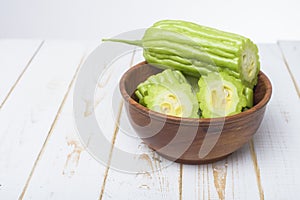 Bitter melon on white wooden table