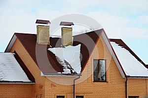 Bitumen asphalt shingles roof. Two chimneys on the roof of the house individual heating.