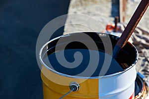 Bitumen in a metal barrel photo