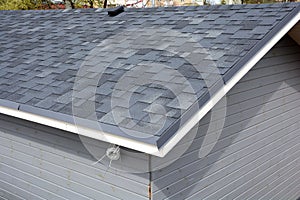 Bitumen tile roof. Roof Shingles - Roofing. Close up view on Asphalt Roofing Shingles