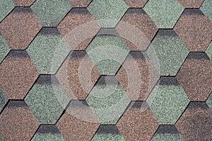 Bituminous tile of hexagonal shape of different colors close-up