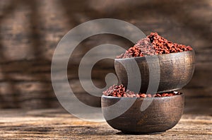 Bixa Orellana - Achiote organic seeds in wooden bowls