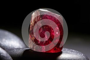 Bixbite Red Bery is a rare precious natural stone on a black background. AI generated. Header banner mockup with space.