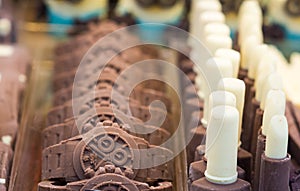 Bizarre chocolate objects. Chocolate formed in wrist watch. Selective focus