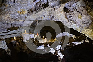 Bizarre and fabulous karst deposits, stalactites and stalagmites, like candles, in the New Athos Cave in Abkhazia