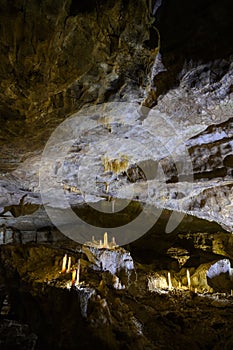 Bizarre and fabulous karst deposits, stalactites and stalagmites, like candles, in the New Athos Cave in Abkhazia