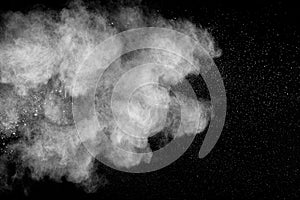 Bizarre forms of white powder explosion cloud against black background.White dust particles splash