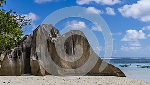 A bizarre granite rock on the sandy beach of Source d`Argent