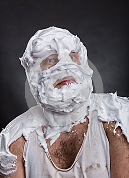 Bizarre man with face completely in shaving foam