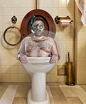 Bizarre man in vintage toilet photo