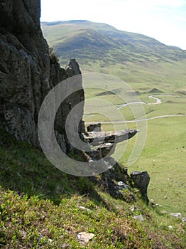 Bizarre rock face and green Hills at Glenshee Valley, Grampian Mountains, Scotland