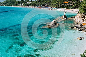 Bizarre rugged white rock cliffs near famous beach of Platys and Makrys gialos with pure clear turquoise sea water photo