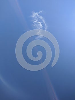 Bizarre shape of the cloud on blue sky